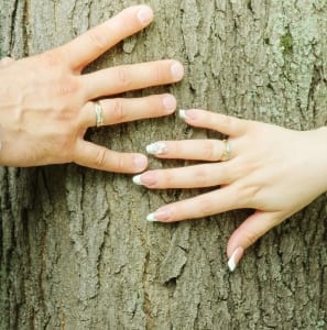 A couple has their hands on a tree- Couples Retreat