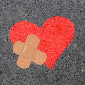 A red heart with a band aid across it-Healing Retreat