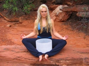 Blonde woman sitting with a large crystal bowl-Detox With Sound-Wellness Retreat