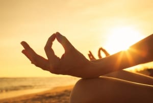 woman meditating at sunrise-Healing Group Retreat