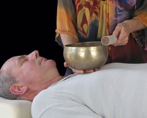 Tibetan bowl ringing over a man's chest-Mens retreat 