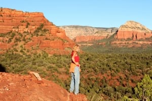 Owner of SpiritQuest Seonda Retreats standing on a red rock mountain 