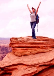 Woman standing on a red rock mountain- SpiritQuest Sedona RetreatsritQuest Sedona Retreats