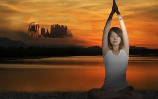 Woman sitting in a yoga position on a misty morning-Yoga retreat