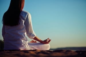 Woman sitting in meditation-SpiritQuest