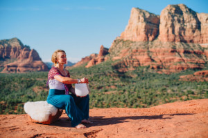 Girl playing crystal bowl for sacred meditation