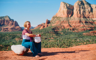 Girl playing crystal bowl for sacred meditation