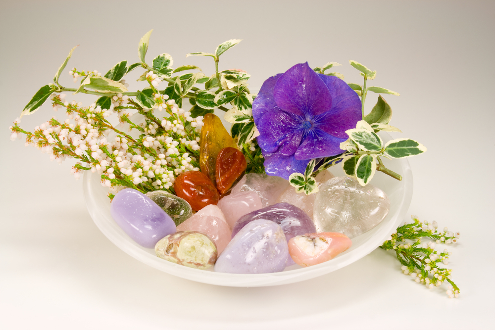 Dish of colored stones and flowers