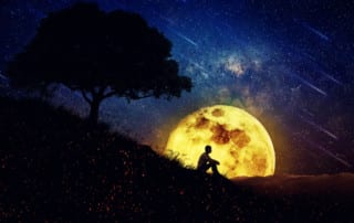 Man sitting in front of moon at night. Fresh Eyes.