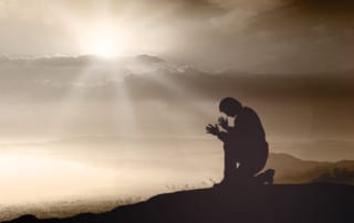 Man prays while on Men's Retreat