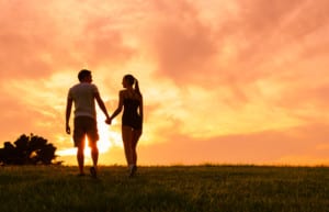 Holding hands at Sunset-Couples Group Retreat