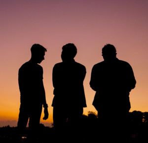 men gathered at sunset-Men's group retreat