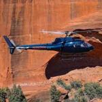 helicopter-sedona-az1 Blue helicopter flying over Sedona red rock canyons during a tour - SpiritQuest Sedona Retreats