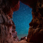 night-sky-sedona-tour Night sky stargazing through a red rock cave opening in Sedona - SpiritQuest Sedona Retreats