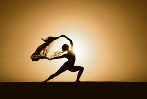 Woman dancing with scarf at sunset-wellness retreat sedona
