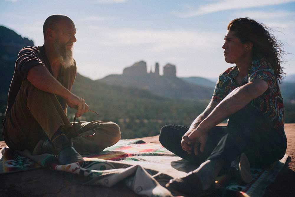 two men sitting on redrocks bell rock shamanic retreat