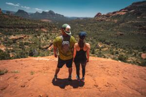 Clients hold hands on red rocks in sedona