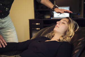 Young woman with hypnotherapist in session. client receives hypnotherapy