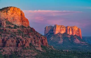 Glowing red rock formations of Cathedral Rock in Sedona at sunset, representing the grounding energy of a desert vortex.
