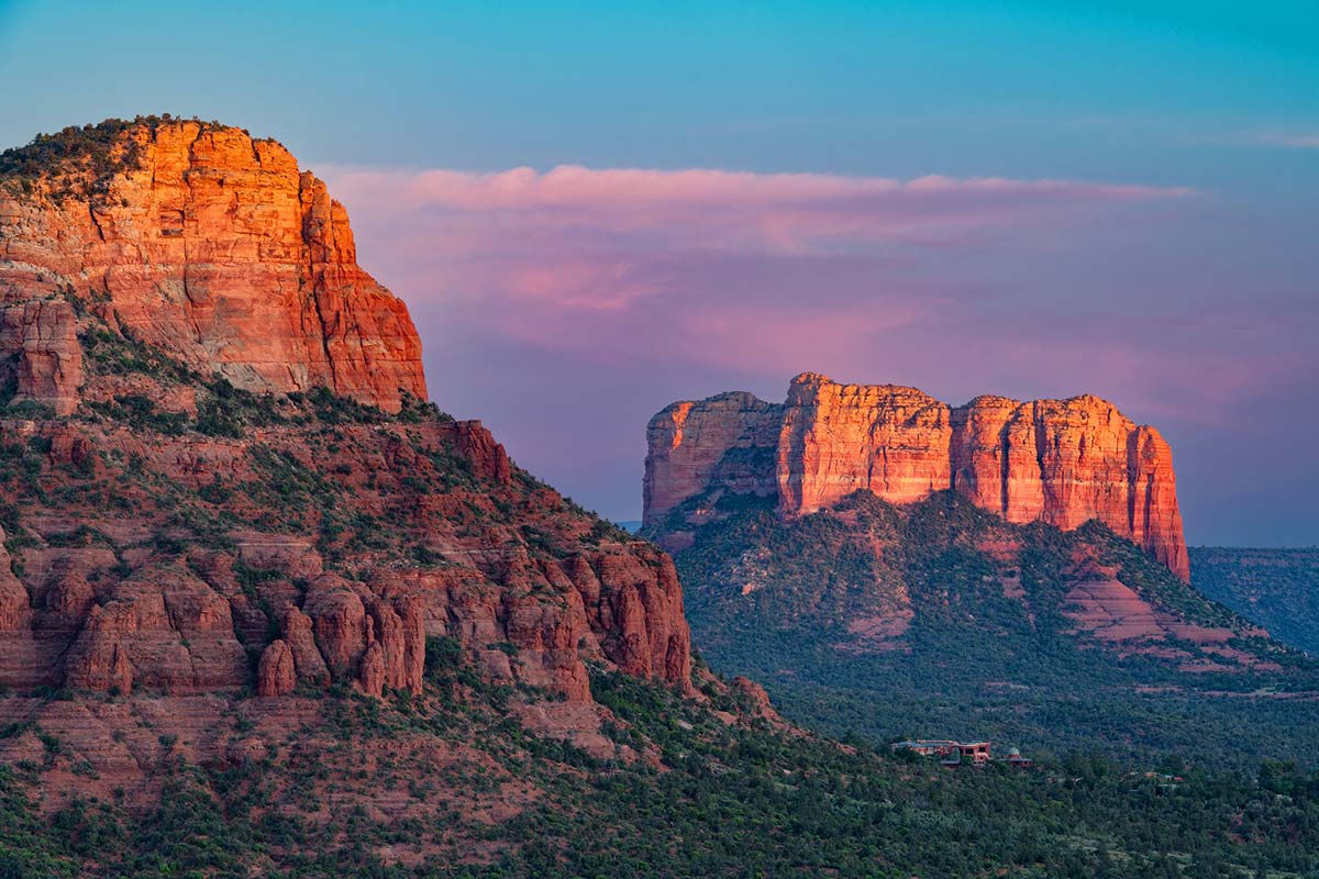 Glowing red rock formations of Cathedral Rock in Sedona at sunset, representing the grounding energy of a desert vortex.