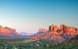 Panoramic view of the Sedona red rocks and city skyline, the sacred setting for the SpiritQuest Method transformation journey.