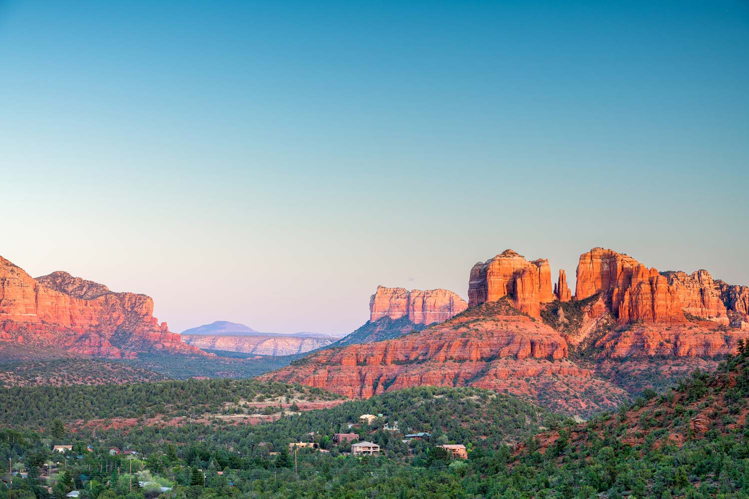 Panoramic view of the Sedona red rocks and city skyline, the sacred setting for the SpiritQuest Method transformation journey.
