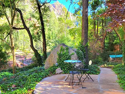Lush green outdoor sanctuary and stone walking path at the SpiritQuest Sedona Retreat Center.