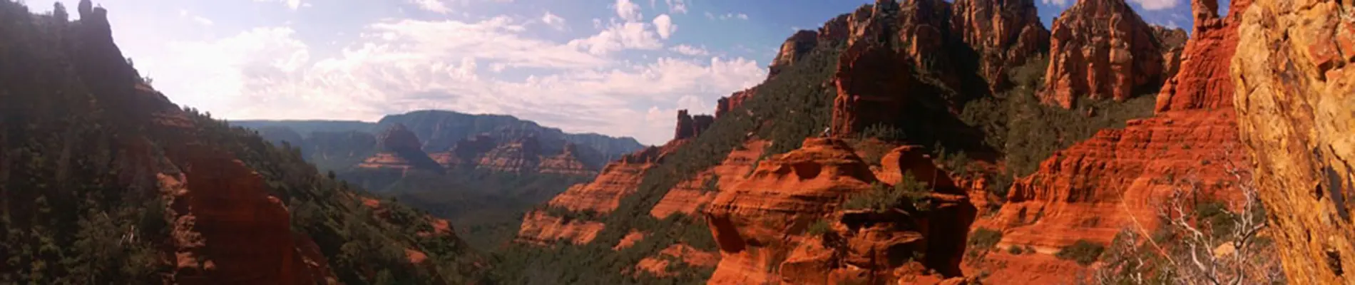 Panoramic view of Sedona red rocks at sunset, the spiritual setting for SpiritQuest healing retreats.