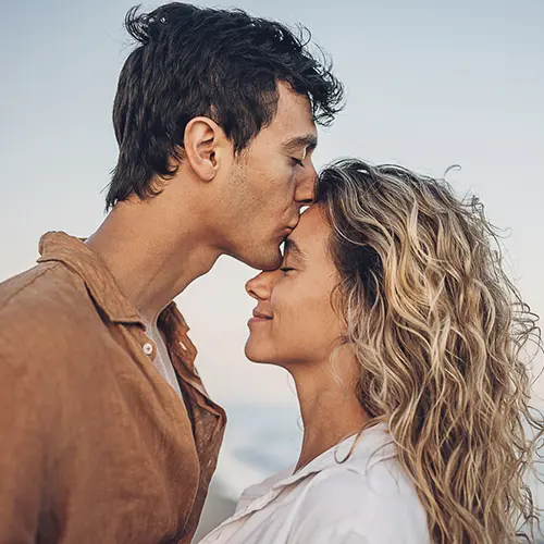 A man kissing a woman on the head during a private couples retreat with spiritquest.