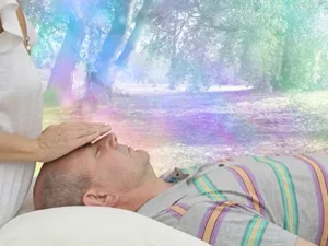 Man receives reiki during wellness retreat at SpiritQuest