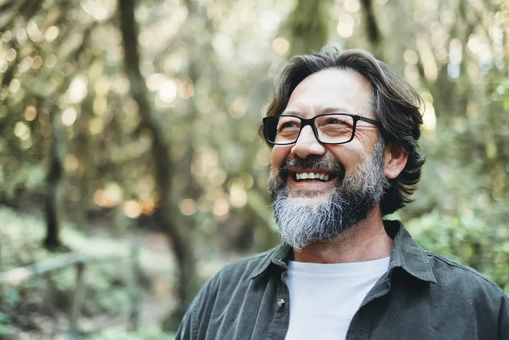 Smiling man experiencing a peaceful moment during a men's retreat in Sedona, Arizona.