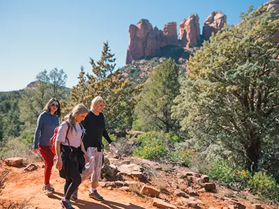 clients hike at a vortex seeking physical and mental balance during a wellness retreat