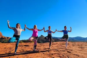 Participants enjoying a guided yoga and meditation session in the heart of the Sedona red rocks.